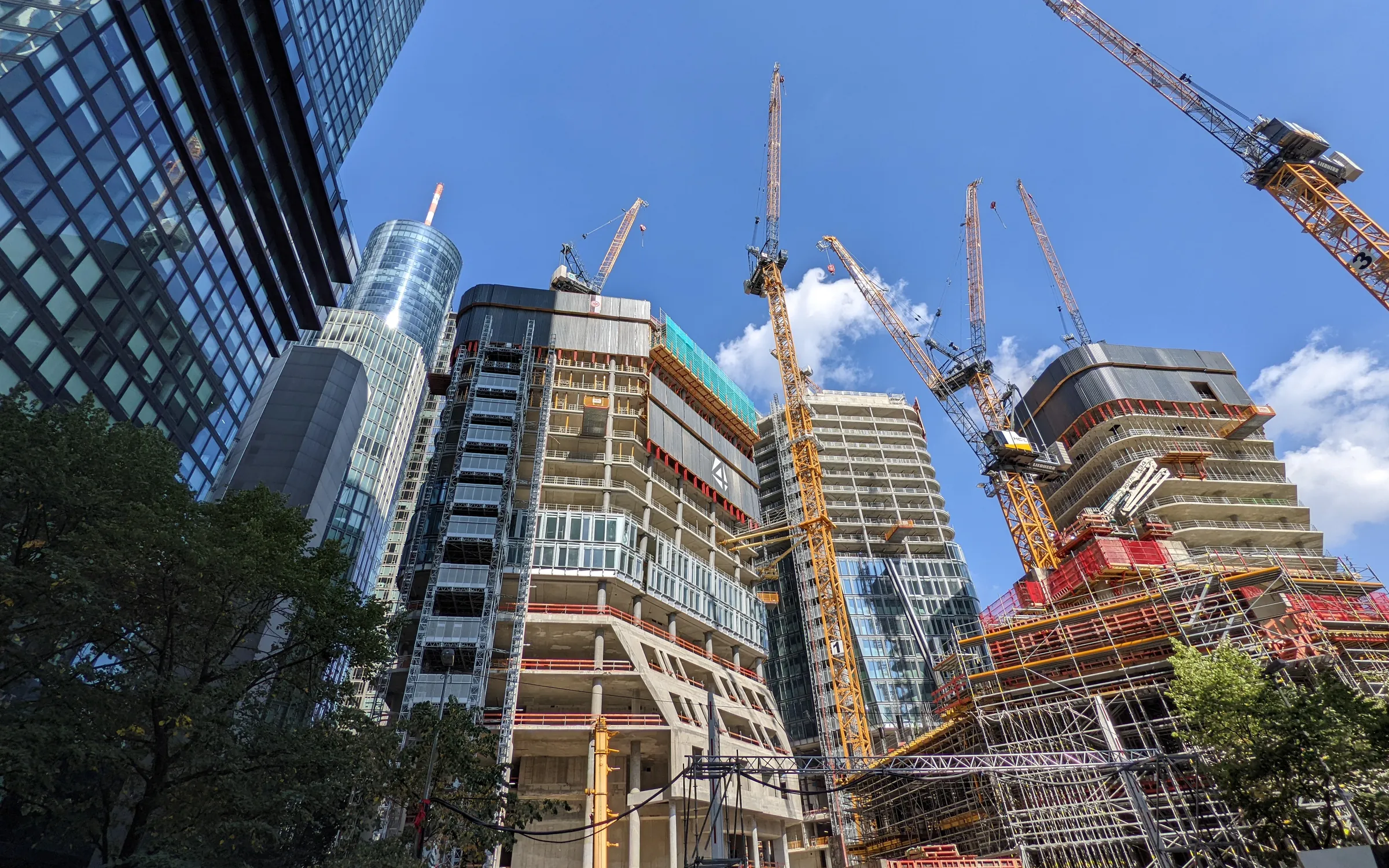 Cranes over a city skyline under construction